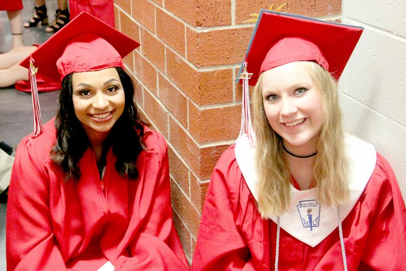 Farmington High School graduates Kaylee Brown and Ashley Burfitt sit in the hallway as they wait to start the 2017 Commencement ceremony. Graduates filed into the ground floor of Cardinal Arena to &#8220;Pomp and Circumstance&#8221; played by Farmington High School Band.