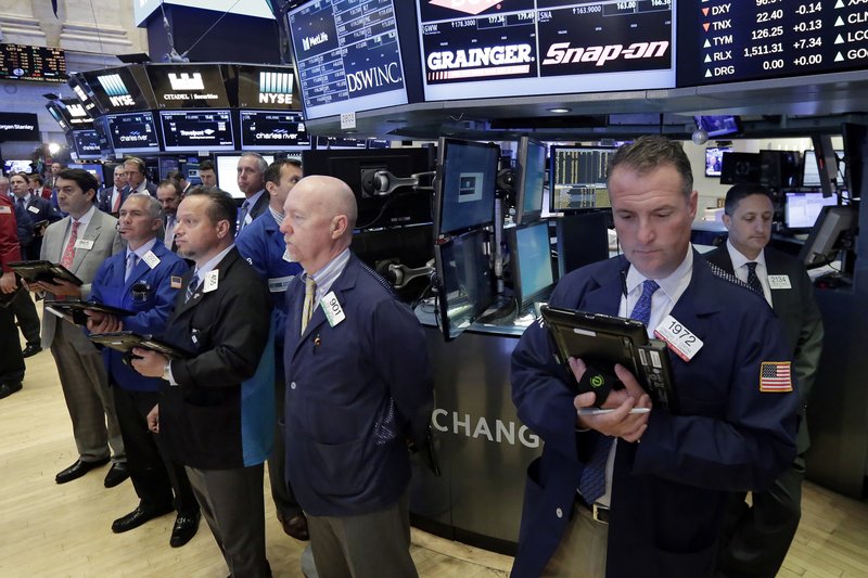 Traders on the floor of the New York Stock Exchange, Tuesday, May 23, 2017, observe a moment of silence in the wake of the attack in Manchester, England. (AP Photo/Richard Drew)