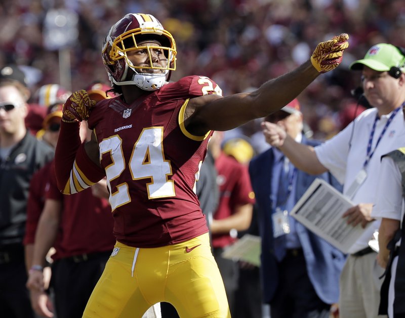 In this Oct. 2, 2016, file photo, Washington Redskins cornerback Josh Norman (24) celebrates his interception with a "bow and arrow" gesture during the second half of an NFL football game against the Cleveland Browns in Landover, Md. 