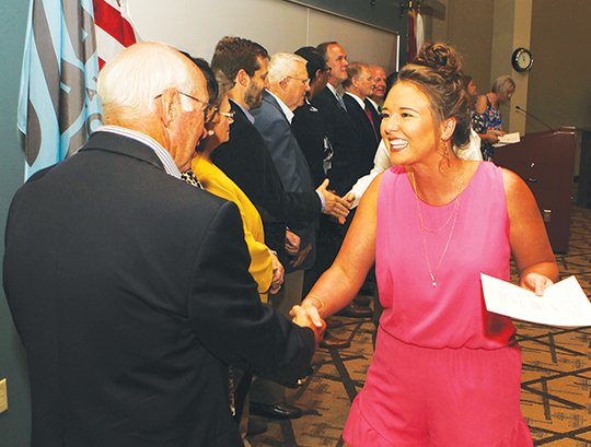 The Sentinel-Record/Richard Rasmussen 2017-18 SCHOLARS: Jessica Dobyns, right, was congratulated by Dennis Smith, chairman of the Oaklawn Foundation board of directors, and scholarship committee members Tuesday after she was presented a $3,000 scholarship for the 2017-18 academic year. The foundation recognized 118 recipients Tuesday in the in the Dr. Martin Eisele Auditorium of the Frederick M. Dierks Center for Nursing and Health Sciences at National Park College. Dobyns will apply her scholarship to Arkansas State University in Jonesboro.