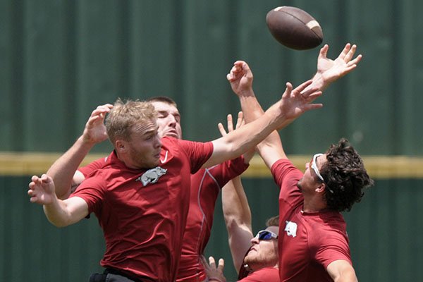 Jake Arledge (from left), Chad Spanberger, Grant Koch and Dominic Fletcher jump for the ball as Arkansas players loosen up with a football Tuesday, May 23, 2017, during practice at Jerry D. Young Memorial Field on the campus of UAB in Birmingham, Ala. 