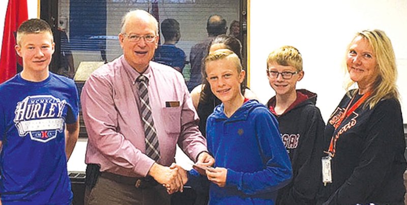 Members of the Gravette Middle School Builders Club recently donated $5,000 to the Northwest Arkansas Children’s Hospital. Shown presenting the check to Malcom Winters, Kiwanis Club president, are Lane Wilkins (left), Winters, Lorelei Kellhofer (in back), club president Jaman Ireland, Michael Duke and Builders Club sponsor Pamela Page. The money was raised through various club projects.