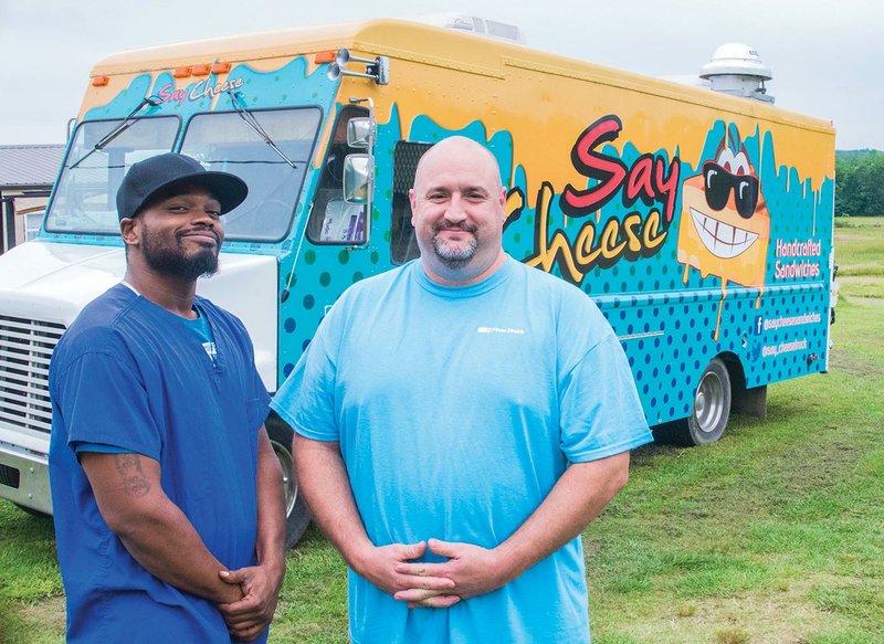 Co-owners Trent Moss, left, and Brian Bostic stand in front of their Say Cheese food truck, which they will work at the Searcy Food Truck Festival on June 3