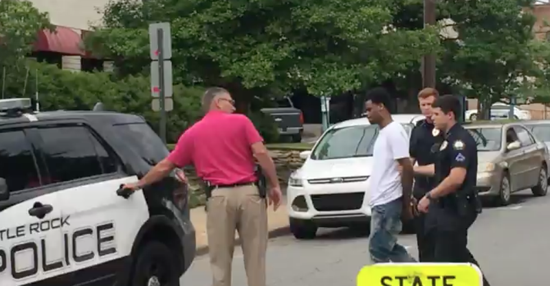 Officers lead Deshaun Rushing, 21, of Little Rock to a patrol vehicle in this file photo. Rushing surrendered to Little Rock police on May 24, 2017. 