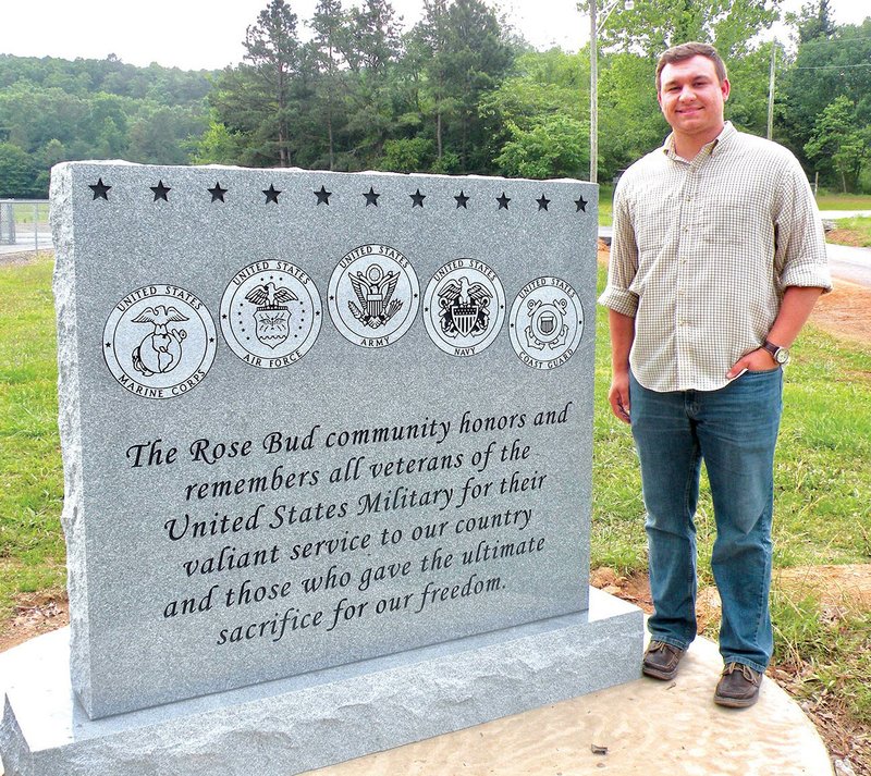 Nick Cartwright shows the Rose Bud veterans memorial that will be dedicated at 1:30 p.m. Sunday at Rose Bud Community Park. The front of the monument, shown here, features emblems for all five branches of the U.S. Armed Services, and the back of the monument bears this Bible verse: “Greater love hath no man than this, that a man lay down his life for his friends.” — John 15:13.