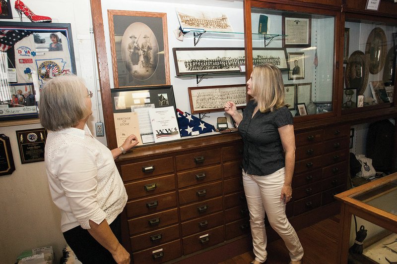 Robbie Cruse Purdom, left, and Renee Rushing Carr take a look at some of the items in the World War I exhibit that is on display at the Stone County Museum in Mountain View. The museum will be the site of a special program — World War I Experiences of Stone Countians — at 2 p.m. Sunday.