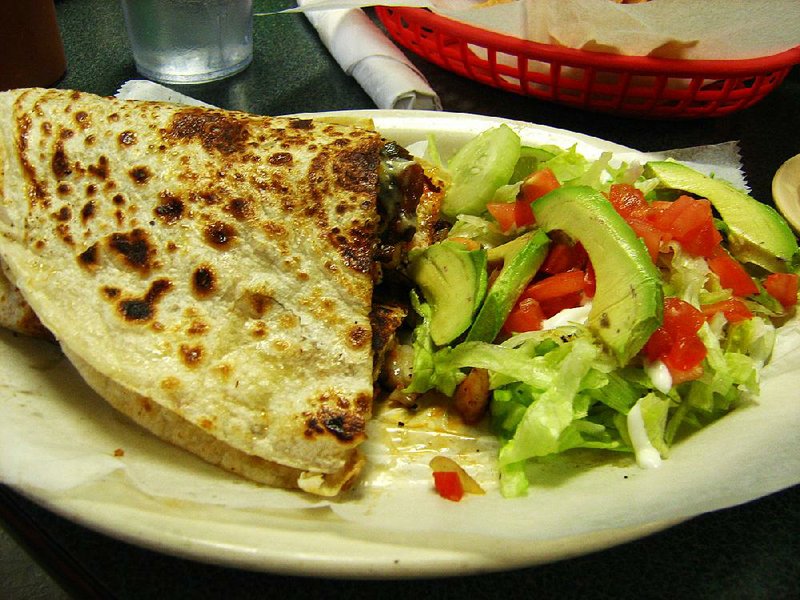 A quesadilla made with steak, marinated pork, spiced pork sausage and smoked beef at Taqueria Jalisco’z in North Little Rock is served with a salad topped with sliced avocado. 