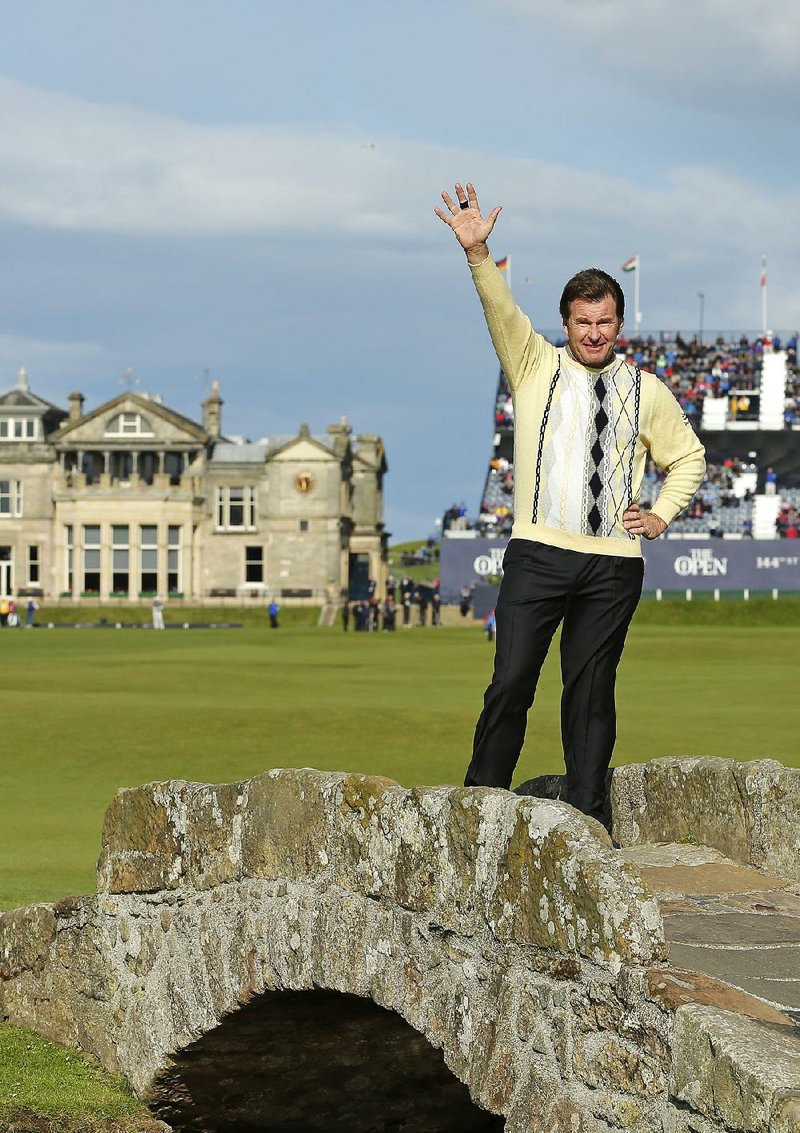 England's Nick Faldo waves as he poses for photographers on the Swilcan Bridge during the second round of the British Open Golf Championship at the Old Course, St. Andrews, Scotland, Friday, July 17, 2015. 