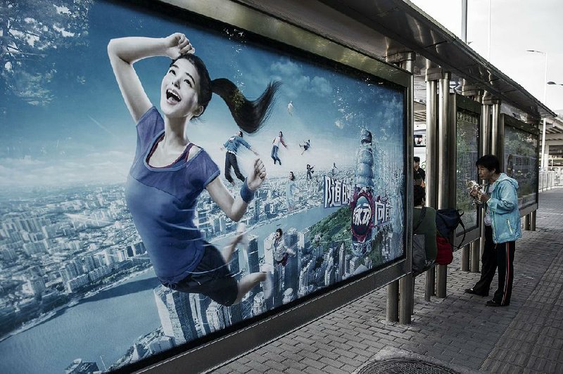 This advertisement at a bus shelter in Beijing earlier this month paints a rosier picture of China’s economy than Moody’s Investors Service’s Wednesday rating reflects. 