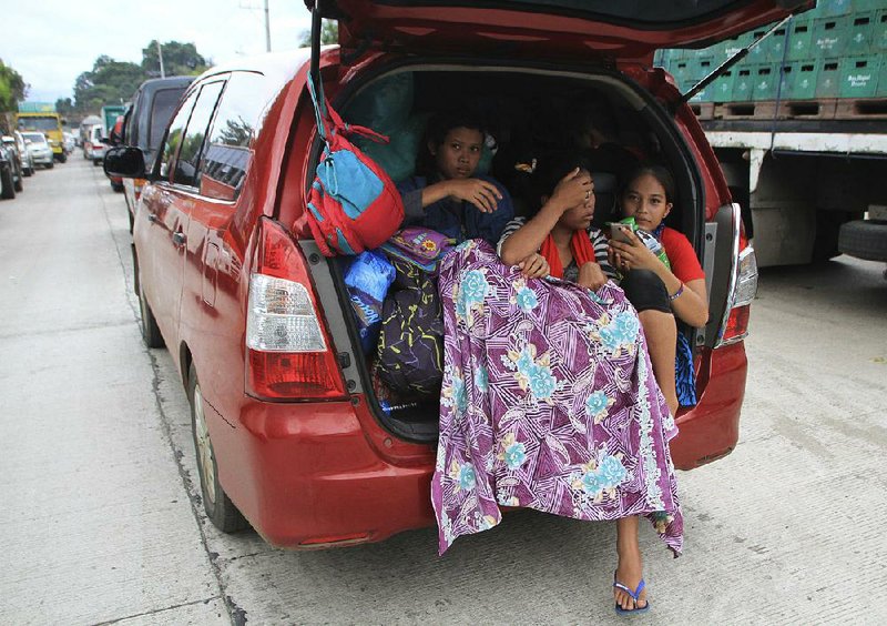 Residents of Marawi city, Philippines, !ee Wednesday after militants linked to the Islamic State moved into the city on Tuesday. Thousands of residents evacuated the city of 200,000 as fighting ensued and fatalities mounted.