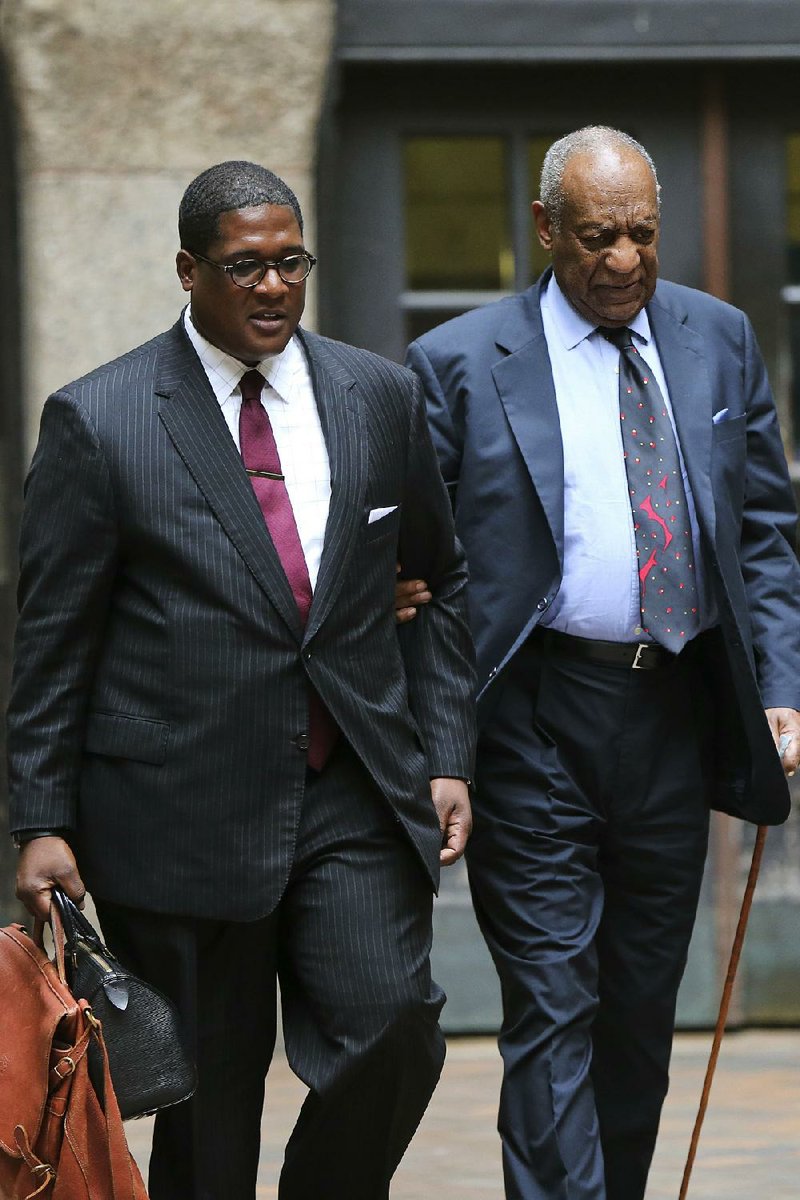 Bill Cosby (right) and his publicist, Andrew Wyatt, leave the Allegheny County Courthouse on Wednesday after the third day of jury selection in Pittsburgh in Cosby’s sexual-assault case.