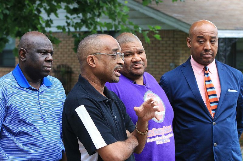 State Rep. Fred Allen (from left), Little Rock City Director Ken Richardson, the Rev. Benny Johnson and Stop the Violence member Walter Crockran speak Wednesday at Charles Bussey Avenue and South Harrison Street in Little Rock about the death of 2-year-old Ramiya Reed and other homicides in the city.