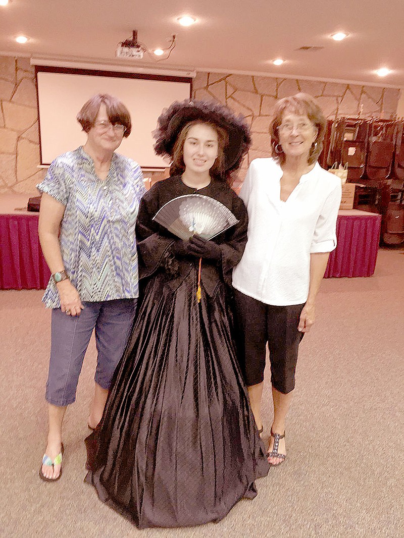 Photo submitted Kayla Reese, center, models a widow&#8217;s dress from the Civil War era during a Noel Woman&#8217;s Club meeting. Also pictured, left, Judy Rickett and Linda Jefferson.