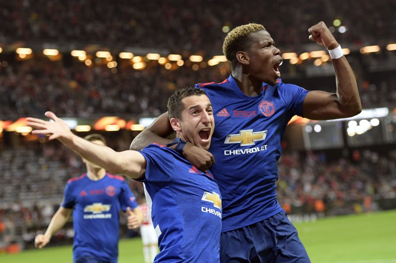 Manchester United's Henrikh Mkhitaryan, left, celebrates scoring with teammate Paul Pogba during the Europa League soccer final match between Ajax and Manchester United at the Friends Arena in Stockholm, Sweden, Wednesday May 24, 2017. 