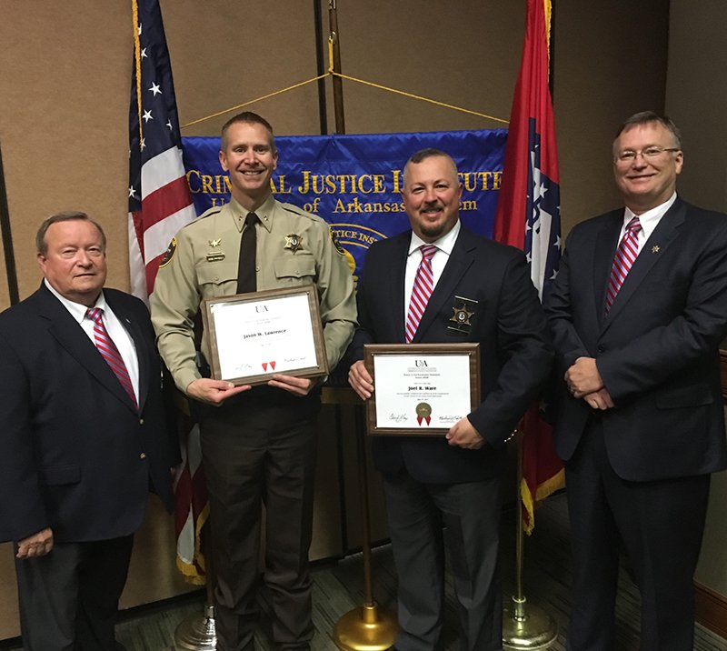 Submitted Photo GRADUATES: Garland County Sheriff's Department Capt. Gary Ashcraft, left, and Sheriff Mike McCormick, right, stand with Undersheriff Jason Lawrence, center left, and Lt. Joel Ware, center right, following Lawrence's and Ware's graduation from the Criminal Justice Institute's School of Law Enforcement Supervision Friday.