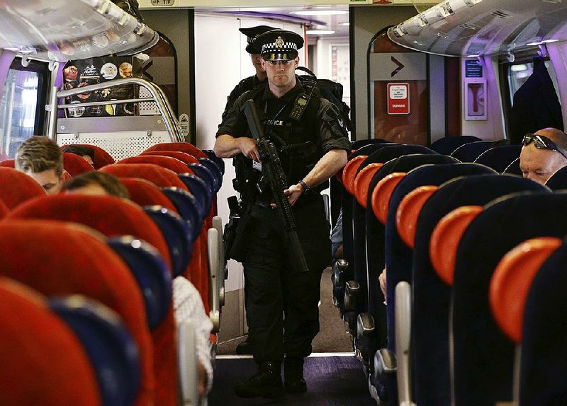 British Transport Police officers patrol a train Thursday in London as a precaution during an increased threat of terrorism.
