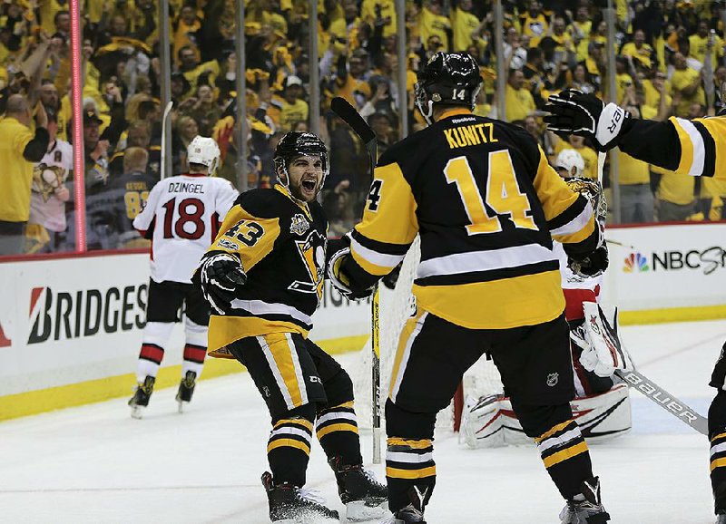 Pittsburgh left wing Conor Sheary (43) celebrates after left wing Chris Kunitz scores a goal in the second period of Thursday’s game against Ottawa. Kunitz also scored the game-winning goal in the second overtime as the Penguins advanced to the Stanley Cup Final by beating the Senators 3-2 in Game 7 of the NHL Eastern Conference finals.