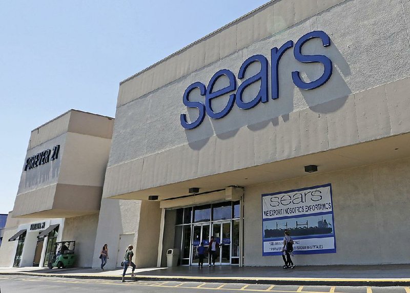 Customers enter a Sears store on May 11 in Hialeah, Fla. Sears Holdings Corp. reported a ÿrstquarter proÿt of $244 million on Thursday. 