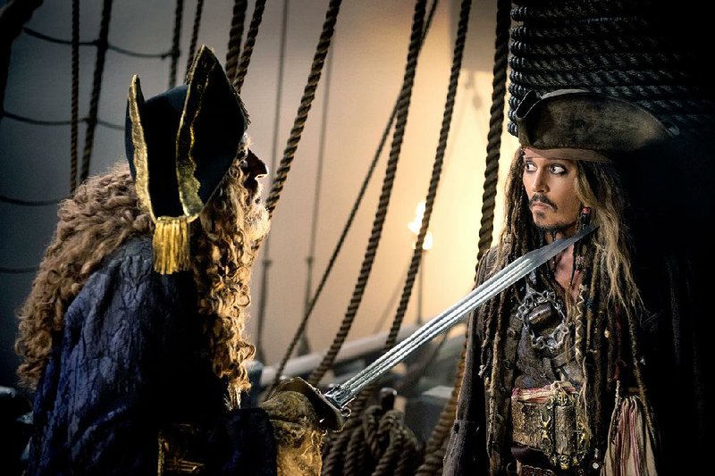Captain Hector Barbossa (Geoffrey Rush) makes a point while debating Captain Jack Sparrow in Disney’s The Pirates of the Caribbean: Dead Men Tell No Tales.
