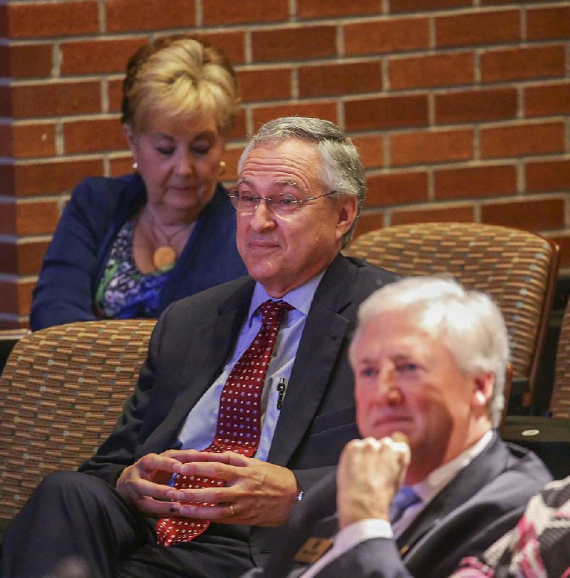 Dr. Dan Rahn (center) was honored by the University of Arkansas board of trustees Thursday for his service as chancellor of the University of Arkansas for Medical Sciences, Little Rock. State Rep Mark Lowery, R-Maumelle (bottom), listens to the presentation honoring Rahn. 