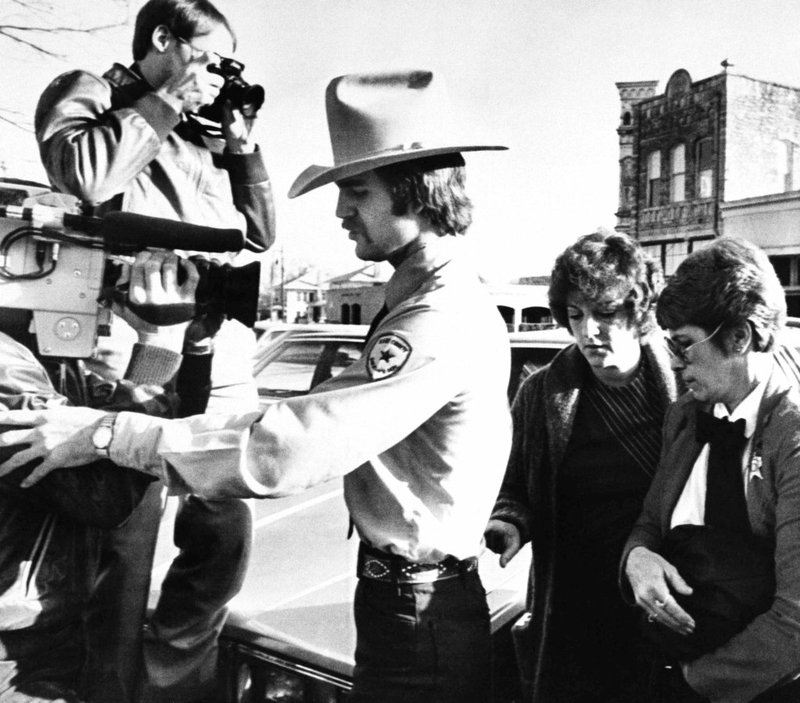 In this Feb. 16, 1984, file photo, Genene Jones, second right, is escorted into Williamson County Courthouse in Georgetown, Texas. 