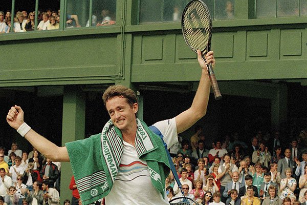 Australia's Peter Doohan raises his arms in victory after defeating defending champion Boris Becker on the Number One Court at Wimbledon, June 26, 1987. Doohan scored a 7-6, 4-6, 6-2, 6-4 victory to eliminate Becker in the second round of the tournament. (AP Photo/John Redman)
 
