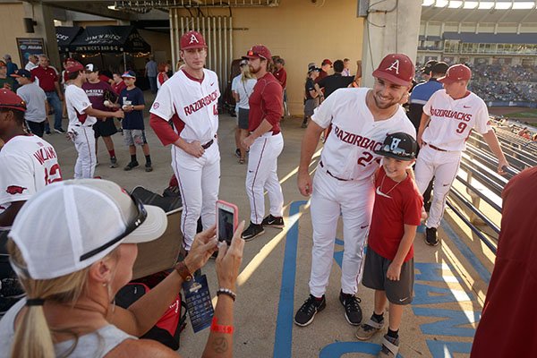 Chad Spanberger, Arkansas first baseman, takes pictures with fans Friday, May, 26, 2017, before a game against Mississippi State at the SEC Tournament in Hoover, Ala.
