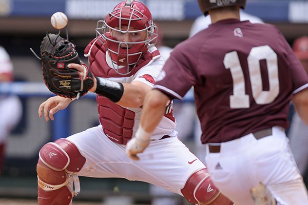 Arkansas catcher Grant Koch can't hang on to the baseball as Mississippi State's Ryan Gridley scores the game-tying run during the ninth inning of an SEC Tournament game Thursday, May 25, 2017, in Hoover, Ala. 