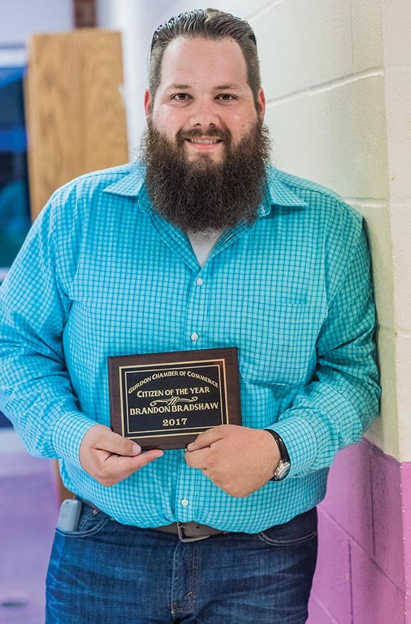 Brandon Bradshaw holds the Citizen of the Year plaque the Gurdon Chamber of Commerce awarded him at its annual banquet Tuesday at Gurdon High School, where he was a fifth-generation graduate.