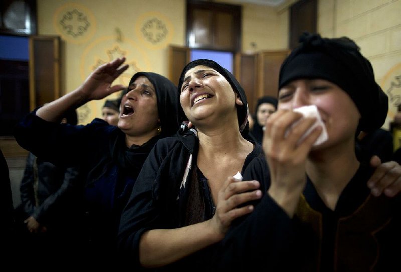 Coptic Christian relatives grieve Friday at Abu Garnous Cathedral in Minya, Egypt, for those killed in an ambush on a bus headed to a monastery, the fourth deadly attack on Christians since December.  