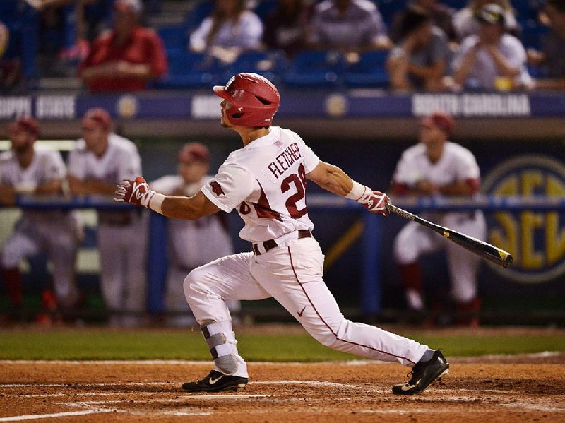 Arkansas center fielder Dominic Fletcher hits a home run to lead off the sixth inning against Mississippi State at the SEC Tournament on Friday night in Hoover, Ala. The Razorbacks scored six runs in the sixth inning and defeated the Bulldogs 9-2 to advance to the tournament semiÿnals, where they’ll face Florida at 4:30 p.m. today.