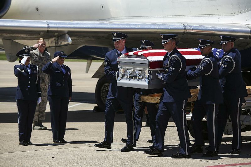 An honor guard carries the remains of Staff Sgt. Robert Dale Van Fossen from a plane May 25 at Bill and Hillary Clinton National Airport/Adams Field for burial with military honors May 27 at Heber Springs. 