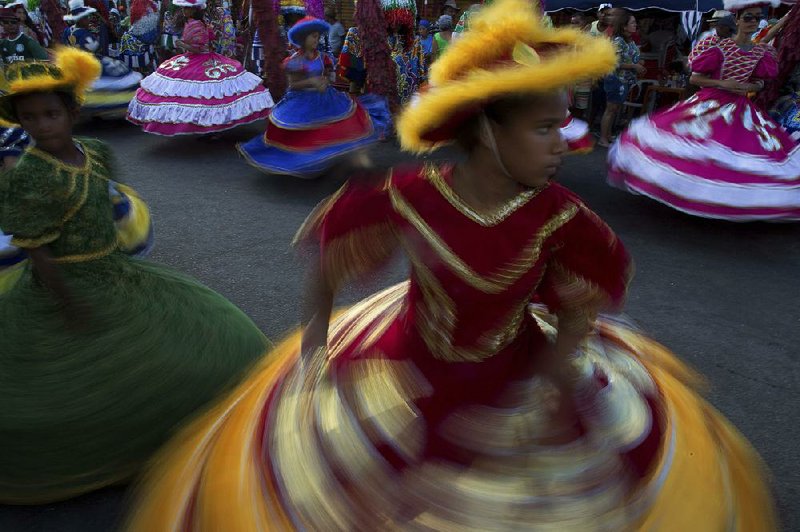 Girls in costume dance in February during Maracatu Carnival celebrations in Nazare da Mata, Brazil. 