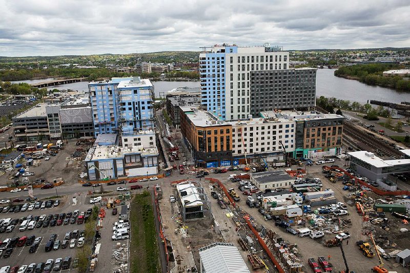 New buildings rise at Assembly Row, a development in Somerville, Mass., spurred by the installation of a rail station. 