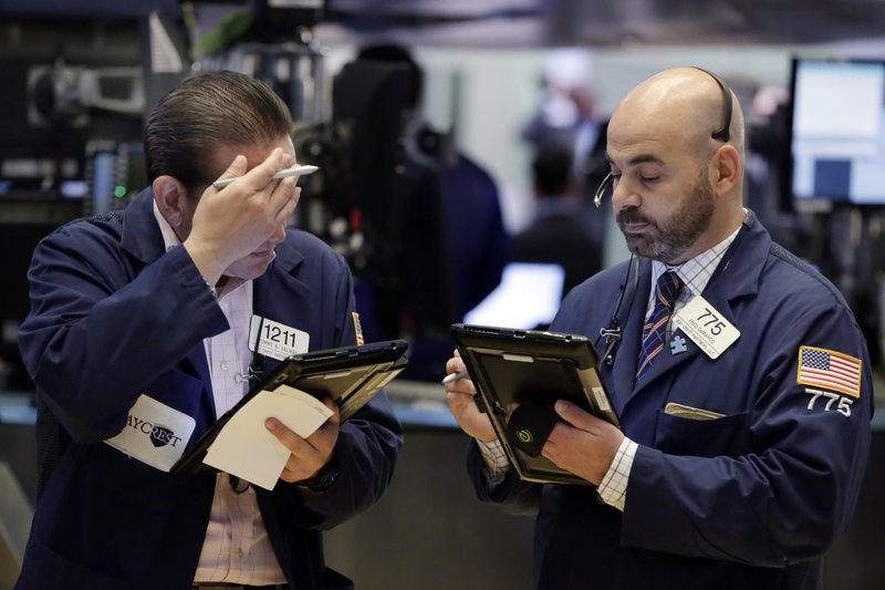 Traders Tommy Kalikas, left, and Fred Demarco work on the floor of the New York Stock Exchange, Friday, May 26, 2017. Stocks are opening a bit lower after a six-day winning streak. (AP Photo/Richard Drew)