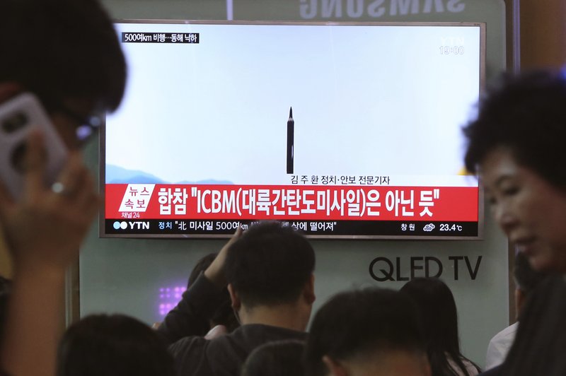 FILE - In this May 21, 2107 file photo people watch a TV news program showing a file image of a missile launch conducted by North Korea, at the Seoul Railway Station in Seoul, South Korea. With North Korea's nuclear missile threat in mind, the Pentagon is planning a missile defense test next week that for the first time will target an intercontinental-range missile. (AP Photo/Ahn Young-joon, File)