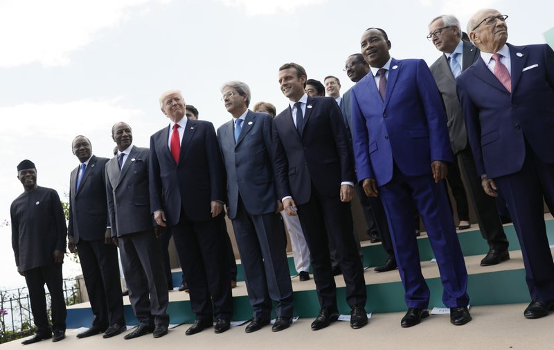 Front row from left to right: Nigeria's Vice-President Yemi Osinbajo, Kenya's President Uhuru Kenyatta, Guinea's President and African Union President Alpha Conde', U.S. President Donald Trump, Italian Premier Paolo Gentiloni, French President Emmanuel Macron, Niger's President Mahamadou Issoufou and Tunisian President Beji Caid Essebsi pose for a family photo with other G7 leaders and Outreach partners during a G7 summit in Taormina, Italy, Saturday, May 27, 2017. 