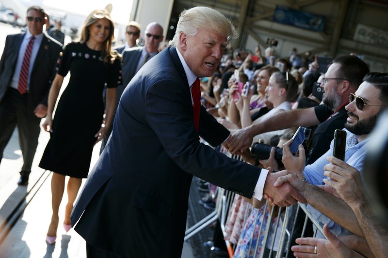President Donald Trump shakes hands as he arrives to speak to U.S. military troops and their families at Naval Air Station Sigonella, Saturday, May 27, 2017, in Sigonella, Italy. 