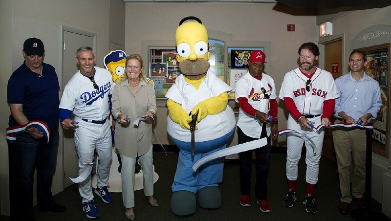 Homer Simpson (center) becomes an honorary member of the Baseball Hall of Fame to celebrate the 25th anniversary of The Simpsons “Homer at the Bat” episode.