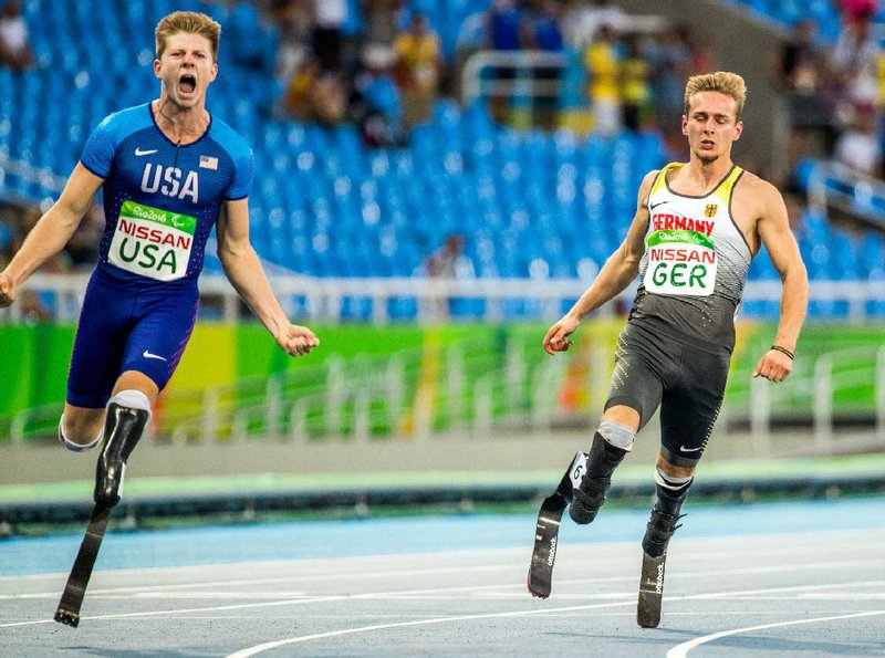 Johannes Floores (right) of Germany and Hunter Woodhall (left) of USA react after the Final Men's 4x100m Relay during the Rio 2016 Paralympic Games in Rio de Janeiro, Brazil, on Monday, Sept. 12, 2016. (Jens B¸ttner/AP Images)