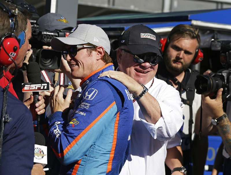 Car owner Chip Ganassi (right) congratulates Scott Dixon on winning the pole position for the Indianapolis 500 earlier this month in Indianapolis. Ganassi has four drivers in today’s race, Dixon, Tony Kanaan, Charlie Kimball and Max Chilton. He also had two drivers in today’s NASCAR Monster Energy Cup Coca-Cola 600 in Concord, N.C., Kyle Larson and Jamie McMurray.