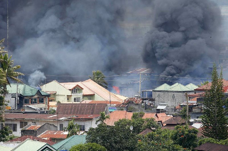 Smoke rises Saturday after airstrikes carried out by the Philippine air force in the battle against militants in the southern city of Marawi. 