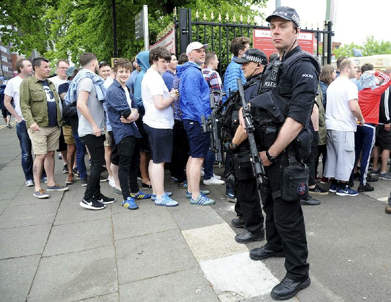 Police watch fans of the Courteeners, a U.K. rock band, arrive for a concert Saturday at Old Trafford Cricket Ground in Manchester, England. The venue is just a few miles away from Manchester Arena, the site of a bombing during a concert last week.  