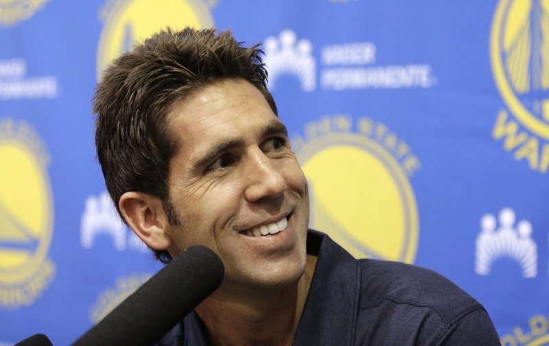 FILE - In this Sept. 22, 2016, file photo, Golden State Warriors general manager Bob Myers smiles during an NBA basketball media availability in Oakland, Calif. Myers has blended a thoughtful, hands-on, hands-off approach with the Golden State Warriors to make him one of the best general managers in sports. (AP Photo/Ben Margot, File)