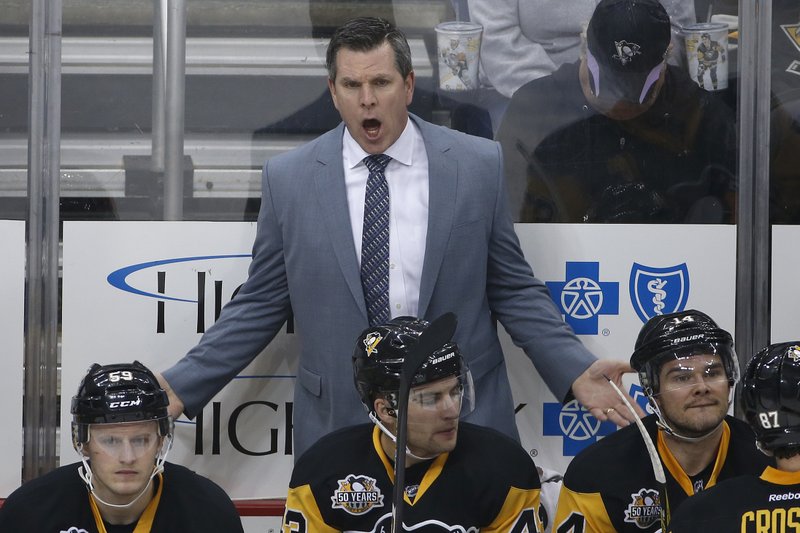 FILE - In this March 3, 2017 file photo, Pittsburgh Penguins coach Mike Sullivan makes his point to an official during the first period of an NHL hockey game against the Tampa Bay Lightning in Pittsburgh. The Stanley Cup has been handed out 89 times to the champion of the NHL since 1927. For the first time, two American coaches will face off in the final as the Nashville Predators' Peter Laviolette goes up against the Pittsburgh Penguins' Mike Sullivan. It's just the seventh time the Cup will be won by a U.S.-born coach.(AP Photo/Gene J. Puskar)