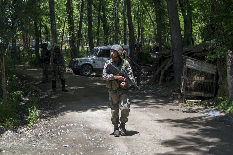Indian army soldiers patrol near the site of a gunbattle at Saimoh village, in Tral area, about 45 Kilometres south of Srinagar, Indian controlled Kashmir, Saturday, May 27, 2017. Rebel leader Sabzar Ahmed Bhat and a fellow militant were killed after troops cordoned off the southern Tral area overnight following a tip that rebels were hiding there, police said. The gunbattle ended later Saturday and soldiers recovered the bodies of two militants. (AP Photo/Dar Yasin)