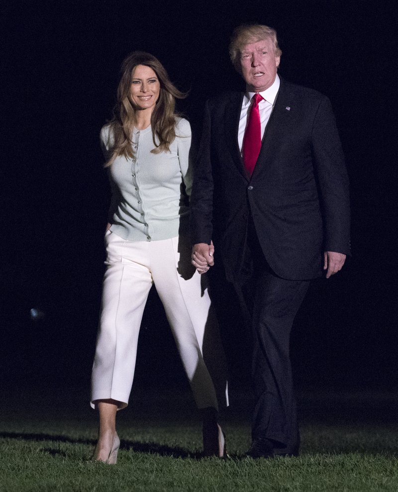 President Donald Trump and first lady Melania Trump walk from Marine One across the South Lawn to White House in Washington, Saturday, May 27, 2017, as they return from Sigonella, Italy.