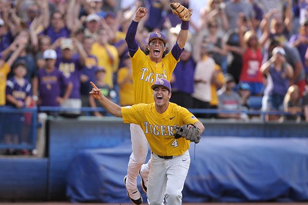 LSU shortstop Kramer Robertson (back) and third baseman Josh Smith celebrate the final out during the Tigers' 4-2 win over Arkansas in the SEC Tournament Championship Game on Sunday, May 28, 2017, in Hoover, Ala. 