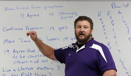 Ray Keller, physical education teacher and head football coach, discusses the results of The R.E.A.L. Man program at with the participants at Oakdale Middle School in Rogers Thursday December 18, 2014. The character development program The R.E.A.L. Man program, respect all people, especially women, always do the right thing and live a life that matters, taught by Ray Keller, a physical education teacher and head football coach, and Jeff Smith, a history teacher and assistant football coach, was offered to eighth grade boys finished after 16 weeks with a recognition ceremony.