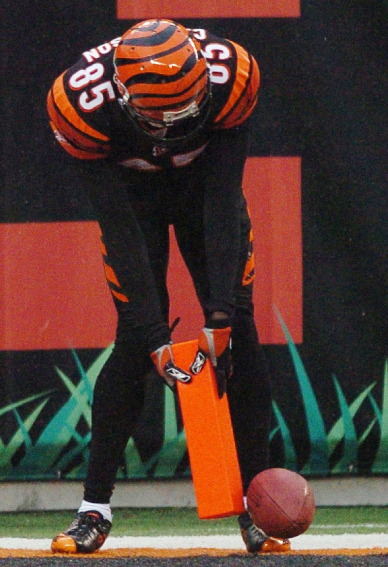 Former NFL wide receiver Chad Johnson putts the football with the goal line pylon after a touchdown during Cincinnati’s game against Baltimore on Nov. 27, 2005. Johnson, who was known for his end zone antics after scoring, said he was a big reason why the league decided to change its policy on celebrations.